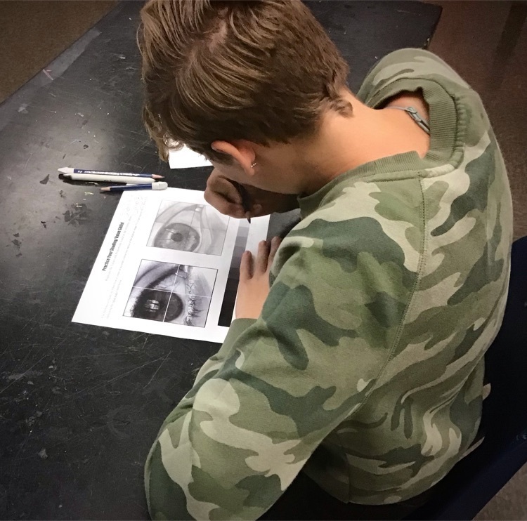 student working on art